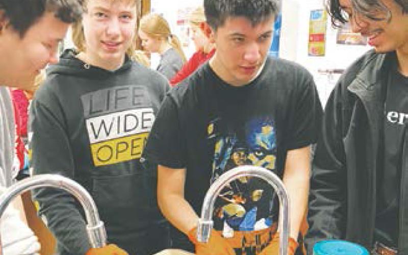 Photo by Lyle Van Camp. Tyler Thompson, Ryan Corrick, Trypp Castillo, and Juan Navaro working on their frog.