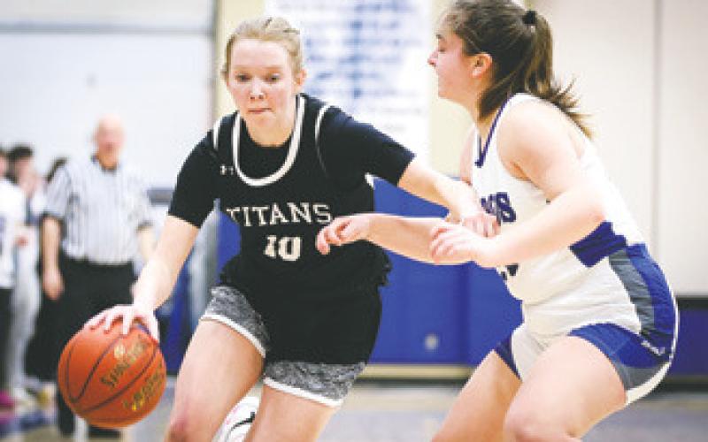 Easton Larson drives by a defender in Friday's Region 2 Play-in game in Hillsboro. Photo courtesy of Corey Erickson, Hillsboro Banner.
