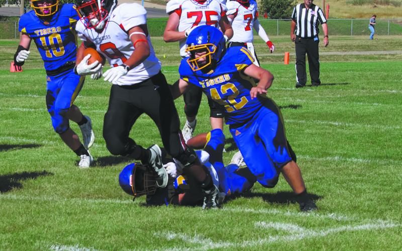 #9 Mason Pollestad drags defenders to make a big gain. Photo by Jamie Rarick