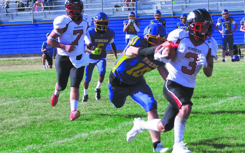 #3 Trenten Bronson-Keena eludes a defender while running down the field. Photo by Jamie Rarick