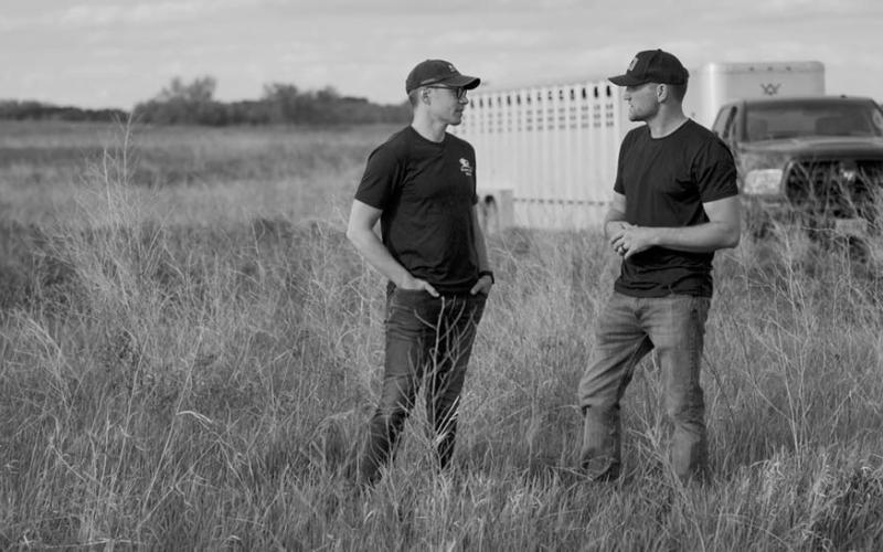 Cory Hepola [left] speaks with Kevin Leier of Heartland Bison Ranch. Photo by The Brookshire Company.