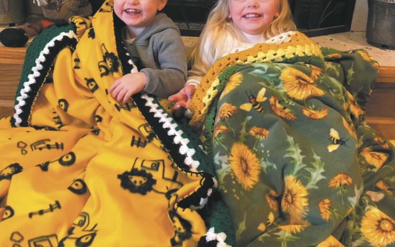 Kolter and Koldie Dahl snuggle under their new Liz’s Kozy Afghans blankets, a Christmas gift from their great-grandmother, Shirley Jensen of Drayton. Photo by Katie Dahl