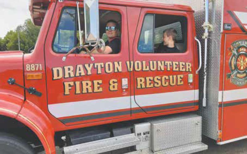 Kids enjoyed firetruck rides throughout Saturday since it was a bit too cool for water games. Photo by Duane H.H. Lyon.