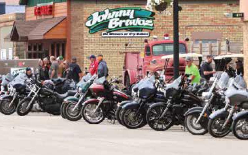 Randy Hills walks past the bikes just before the start of the Tom Landowski memorial ride on Saturday. Photo by Lyle Van Camp.