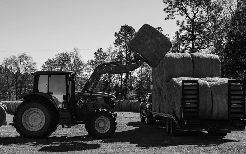 Loads such as seed, fertilizer, equipment and hay bales are subject to vibration, swaying, centrifugal force, inertia, wind and other forces during transit. (USDA photo)