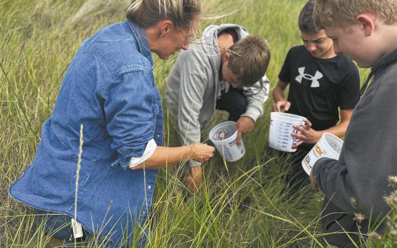 Artist Austen Camille [left] along with North Valley CTE students Aaron Linner, Kale Tanke, and James Elliott collecting prairie soils they later rendered into paint pigments during the Thinking Like a Prairie workshops. Photo provided by Josh Anderson.