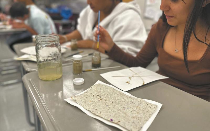 Students Julissa Garcia, and Daphneiris Almonte from the North Valley CTE program paint on prairie paper with pigments made from local soils as part of the Thinking Like a Prairie workshops. Photo Josh Anderson.