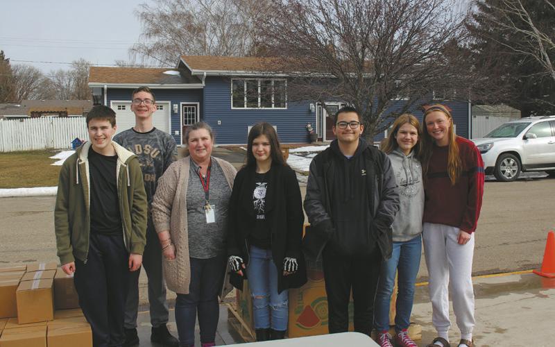 Local students volunteered at the Great Plains Mobile Food Bank held in Drayton on March 20. They worked to unload the truck and distribute food parcels to families The event is sponsored by Drayton's FCCLA and National Honor Society groups. Pictured from left to right: Loki Sylskar, Jonah Rarick, Mrs. Quimby, Brookelynn Petersen, Gunnar Kuznia, Violet Hoyles, and Peyton Larson. Their next mobile food bank will be on June 19 at the front of Drayton school. Submitted photo