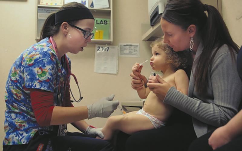Nurse Julianna Emanuel administers a hepatitis A vaccine shot at the Sanford Children's Clinic in Fargo. Photo by Dave Wallis, courtesy of The Forum.