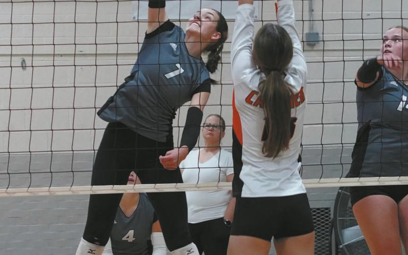 Elizabeth Fedje slams down one of her 15 kills in the Titans win over Cavalier Oct 3 in Cavalier. Photo by Larry Stokke