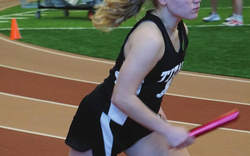 Reese Fering runs her leg of the girls 1200 meter relay at the Pembina County Indoor Track Meet last Saturday. VNV photo by Lyle Van Camp