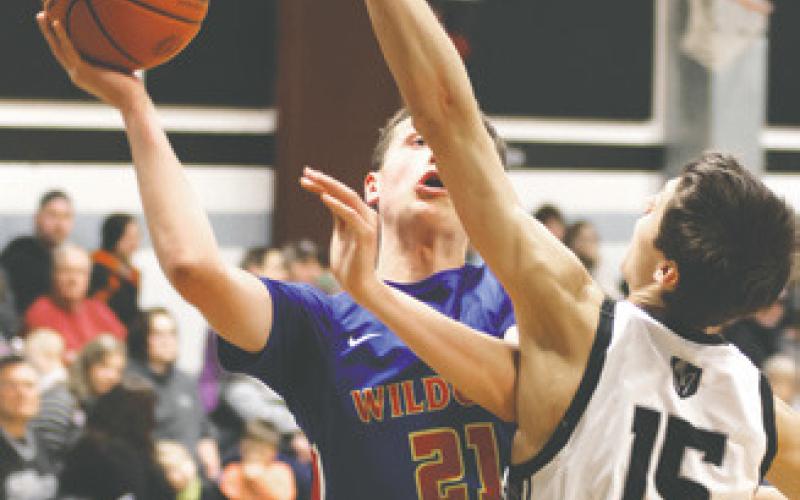 Jayse Gullickson tries to stop Benson County's Gunnar Larson. Photo by Lyle Van Camp.