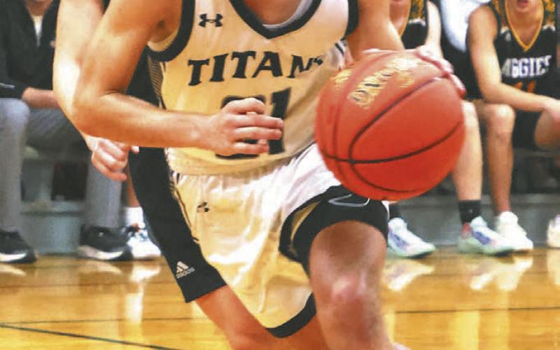 Trenten Keena brings the ball up the court in action against Park River.