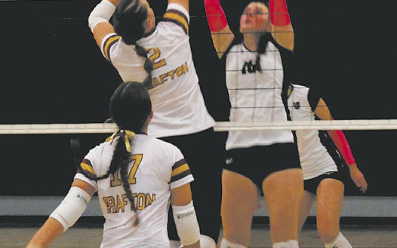 Going for the block, DVE's Ingrid Myrdal jumps in front of Grafton's Julia Heidt. Photo by Jamie Rarick.
