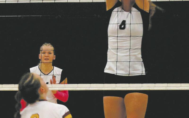 Peyton Larson leaps for the block, sending it back to the Spoilers. Photo by Jamie Rarick.