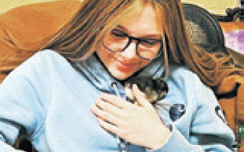 Taylor Hermanson cuddles a newly hatched chick. Photo submitted by Adam Riddle.