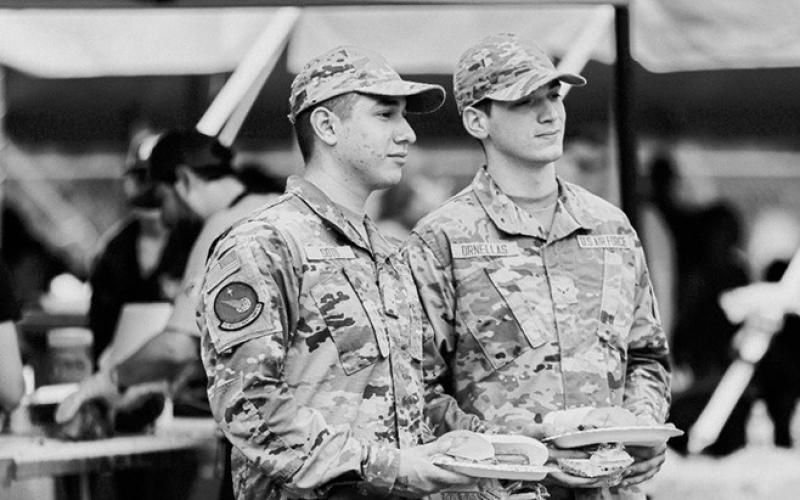 Military personnel enjoy their beef meal.