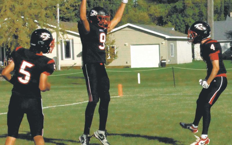 Lucas De Souza and Trypp Castillo celebrate with Mason Pollestad following Pollestad's impressive touchdown. Photo by Jamie Rarick