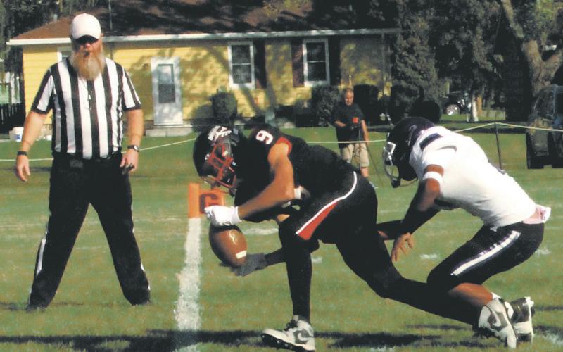 Recovering a Braves fumble, Mason Pollestad runs in for a Bomber touchdown. Photo by Jamie Rarick.