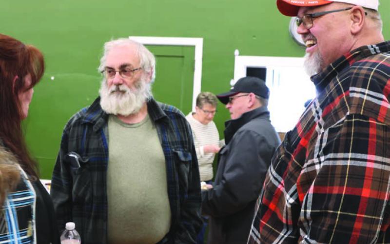 Lisa, left, and Don, right, Staskivige visit with a friend during the benefit Saturday.