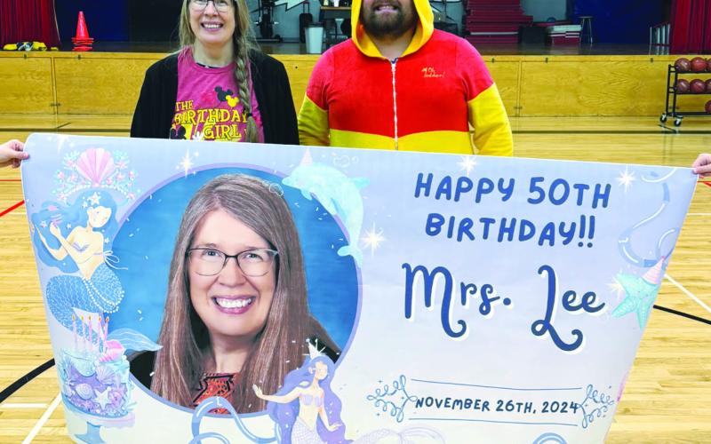 Mrs. Lee and DHS Athletic Director Raven Smith with her birthday banner. Photo courtesy of Drayton School.