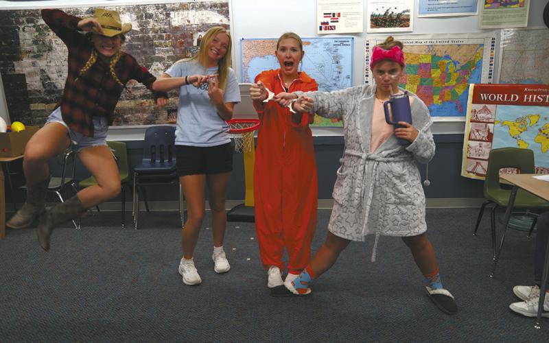 Seniors Reese Fering, Easton Larson, Rylee Maurstad, and Aleah Pokrzywinski pose as “Wild West, Blessed, Under Arrest, and a Hot Mess” for Rhyme with no Reason Day. Photo by Jamie Rarick