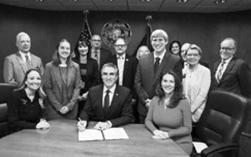 On March 24, Gov. Doug Burgum signed House Bill 1398, requiring K-12 public and non-public schools to provide instruction in computer science and cybersecurity. Kirsten Baesler, state superintendent of public instruction, is to Burgum’s right. Photo courtesy of the Governor’s Office.