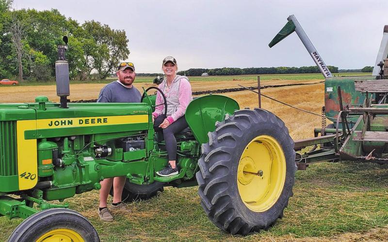 Kameron and Katie (Jensen) Dahl carry on the legacy of farming. Katie had the honor of taking the last round on Saturday afternoon. Photo by Kim Hemmes