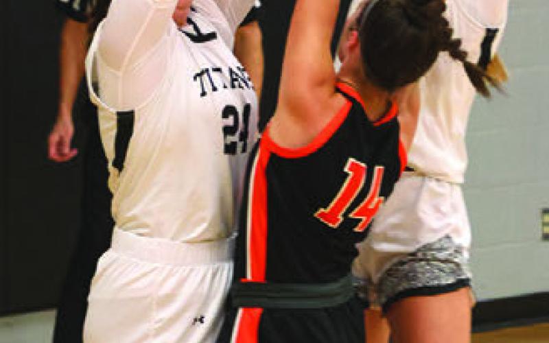 Hailey Berg and Easton Larson try to stop Cavalier's Grace Thorlakson.