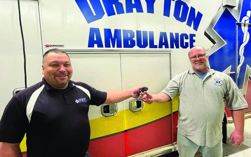 Premier Specialty Vehicles’ Mark Rethwisch hands the keys for the new ambulance to Drayton Ambulance driver Paul Larocque.