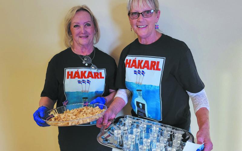 Noreen Carpenter and Jeanette Bjornstad prepare the hákarl and brennivin for the appetizer table.