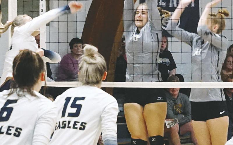 Emily Gonzalez and Claire Thompson both go for a dig against the NB Eagles. Photo by Larry Stokke Kiara Assand with a stuff block against the North Border Eagles . Photo by Larry Stokke.