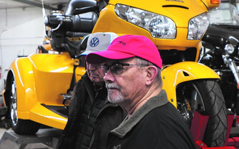 Lloyd Thompson and Darrell Aipperspach check out the motorcycles at Street is Neat in Oslo with a bright yellow Honda trike in the background. Photo by Lyle Van Camp.