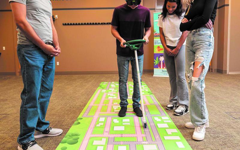 Students were challenged to steer a car on a track while wearing Polydrug Goggles that distorted their view as if intoxicated. Submitted photo.