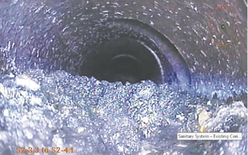 Sludge buildup in the sanitary sewer is caused by slow water flow through the pipe. Slow flow allows solids to settle into the pipe and will cause sewage backup. Photo courtesy of Moore Engineering.