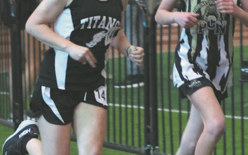 Violet Hoyles passes a Pembina County North competitor in the girls 1500. Photo by Lyle Van Camp