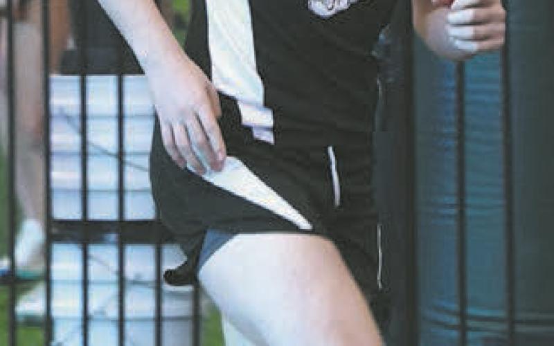 Gavin Cole running a leg in the boys 4 X 300 relay. Photo by Lyle Van Camp.