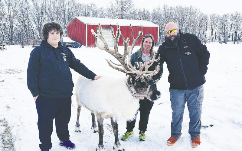 Austin, Olaf, Shannan, and Kyle pose for a family photo at Reindeer Ranch. Photo by Hilary Nowatzki.