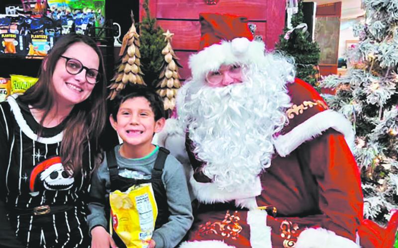 Santa visited with shoppers at Halcrow's during Drayton's Old Fashioned Christmas. Photo by Christine Jensen