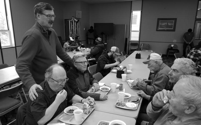 Assembly of God Superintendent Winston Titus visiting with some of the Drayton men. Photo by Tanio DeSousa.
