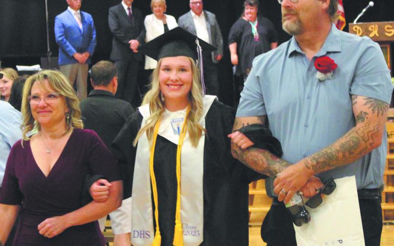 Rylee Maurstad exited the ceremony on the arms of her parents, Jamie and Ian Mattice. Photo by Andrea Johnston