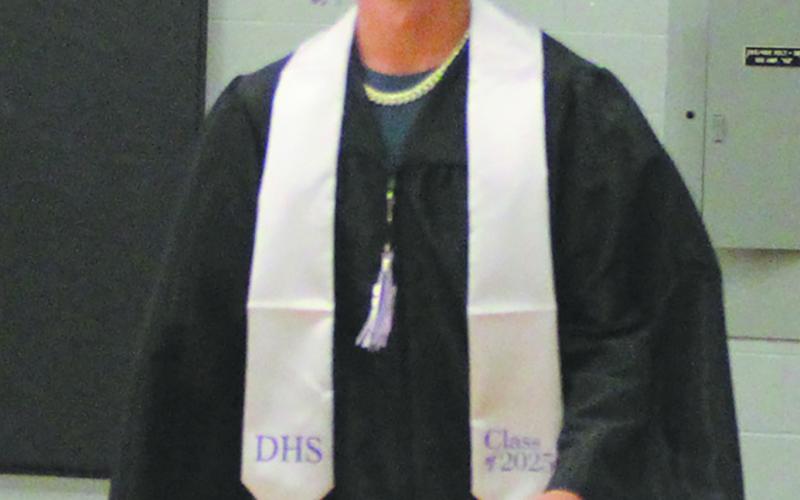 As he enters the ceremony, JJ Knudson was all smiles. Photo by Andrea johnston