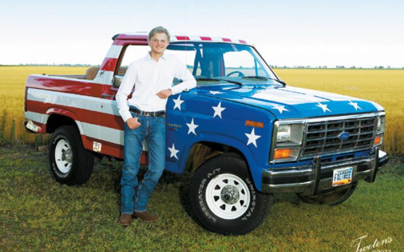Rural Drayton teen Cody Narloch, who is a senior at Grafton High School, stands with 'Patriot' a 1984 Ford Bronco he restored with the help of family and friends. Photo Courtesy of Rock Tweten, Tweten's Photography, Grafton.