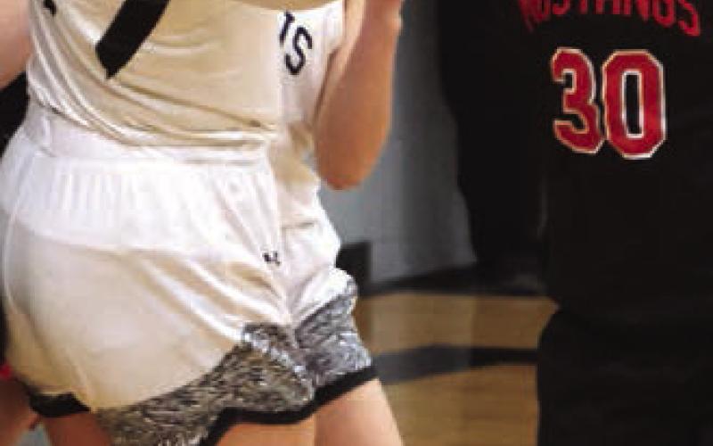 Alyvia Quibell fights Midway-Munto's Daisy Monson for a loose ball.