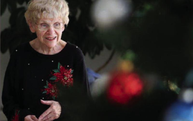 Saralee Hoselton at the end of December posing amid Christmas decorations in the community room of her Drayton apartment complex as she discusses her next column. Photo by Eric Hylden, Grand Forks Herald
