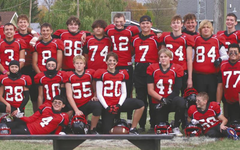 The Bombers players and coaches possed for photos after winning their semi-final game last Saturday. Photo by Lyle Van Camp