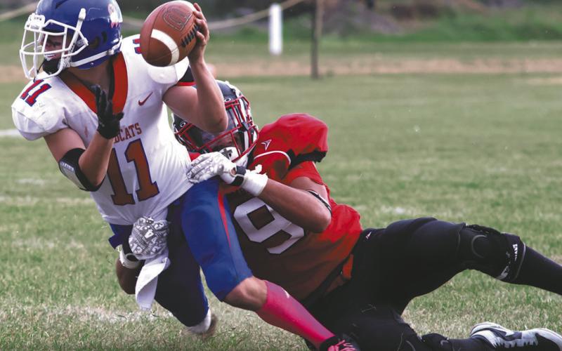 Mason Pollestad wraps up Center-Stanton's Hudson Buchholz-Casson. Photo by Lyle Van Camp