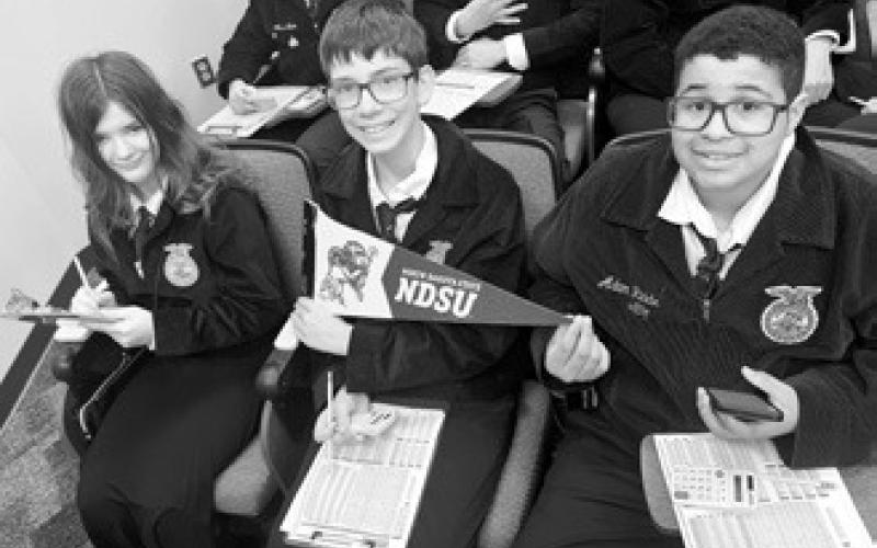 From left to right: Brooklyn Petersen, Jonah Rarick, and Jeremiah Johnson studying at the FFA State Convention. Photo by Adam Riddle.