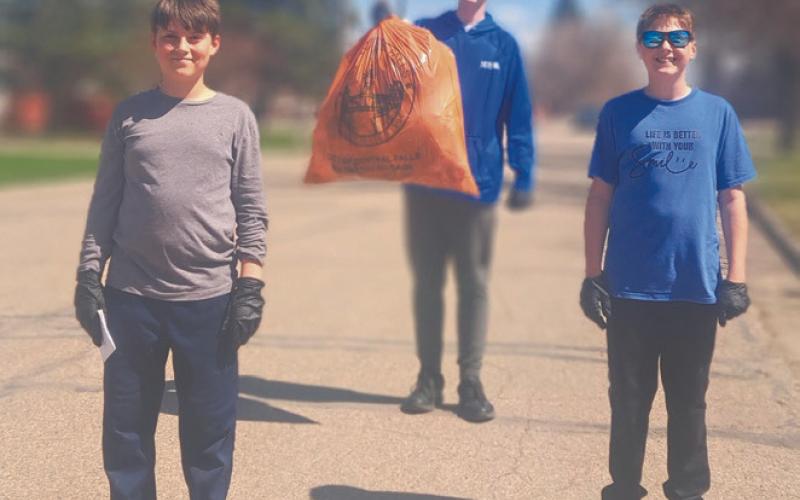 Ezra Adkins, Jonah Rarick, and Jasper Halvorson did their part to clean up the town. Photo by Christine Jensen
