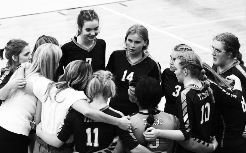 The Titans and coaches Jodi Fedje and Sara Gullickson huddle up between sets in their match Sept. 27 vs. Park River.